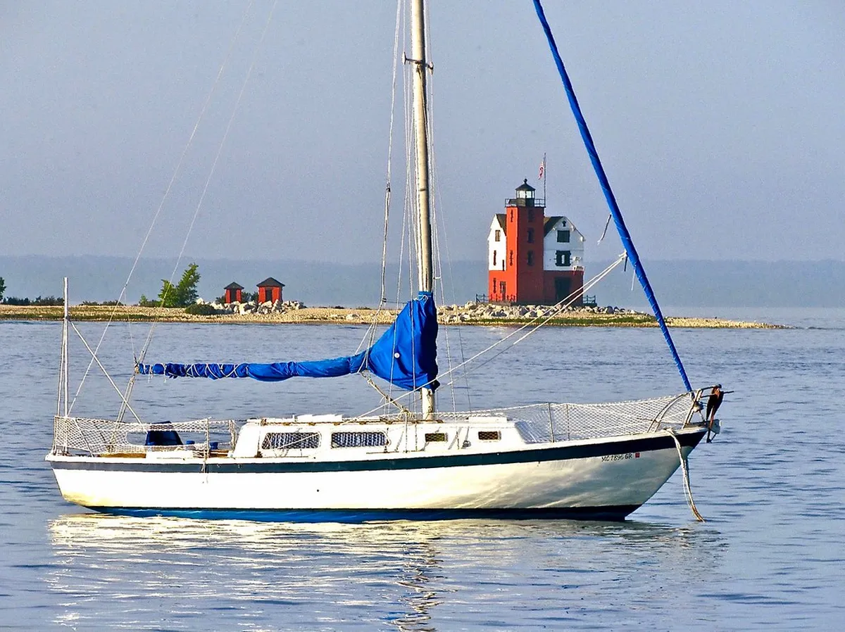 Sailboat anchored near Round Island Lighthouse by Mackinac Island
