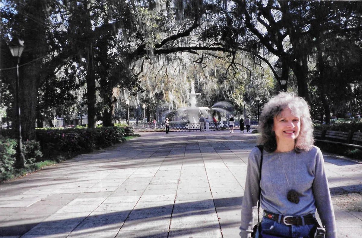 Visitor beneath live oaks near the Forsyth Park fountain in Savannah