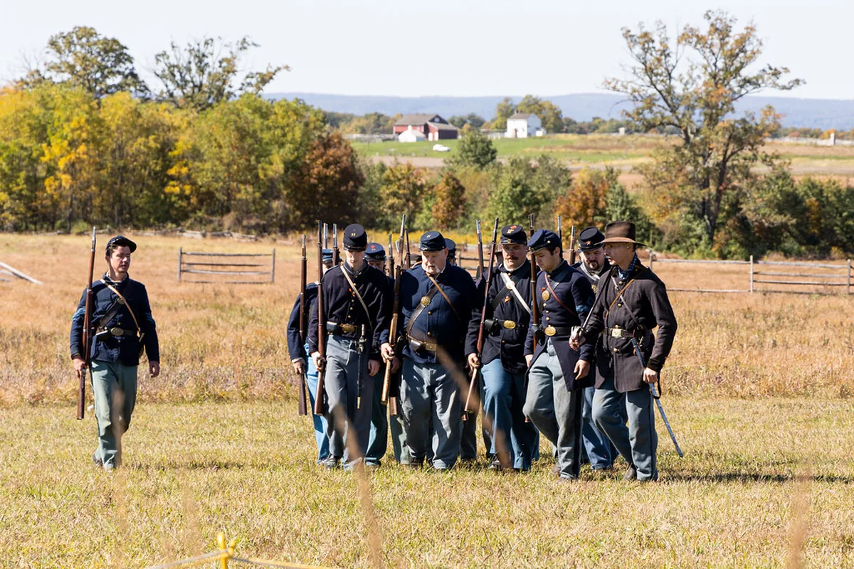 Civil War reenactors crossing the Gettysburg battlefield in Pennsylvania